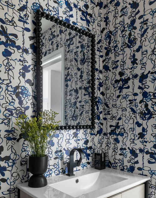 Powder bath with cobalt blue abstract floral wallpaper and modern black accents