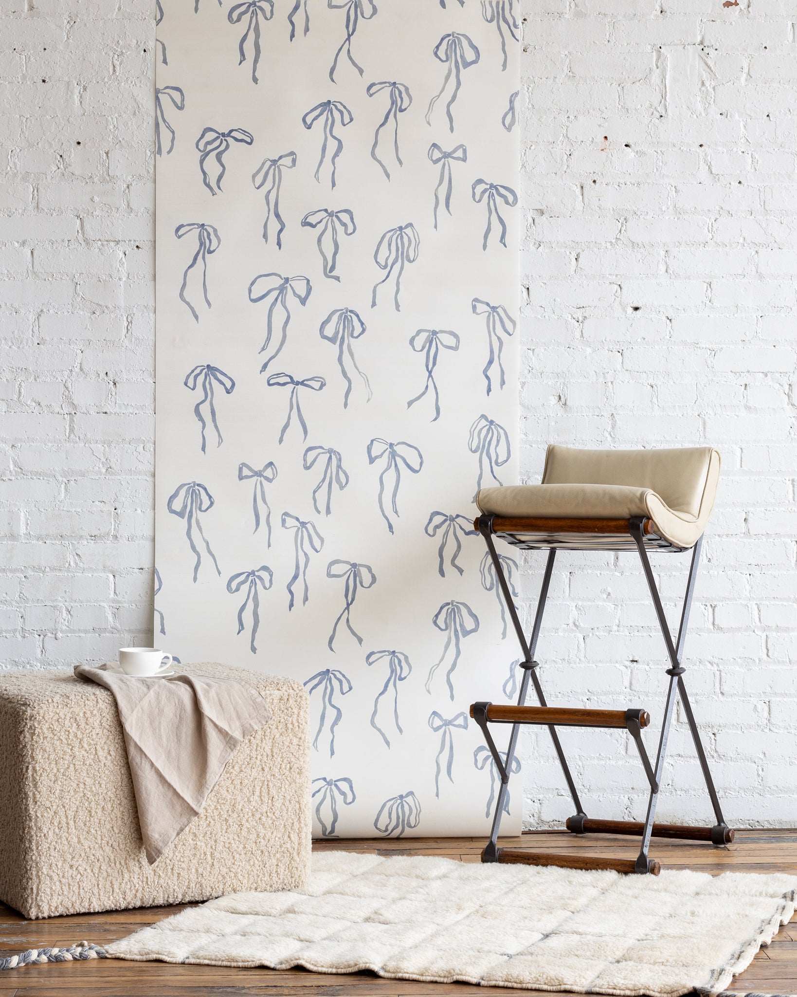 Elegant silk wallpaper in Denim featuring a whimsical bow motif - perfect for creating a statement wall