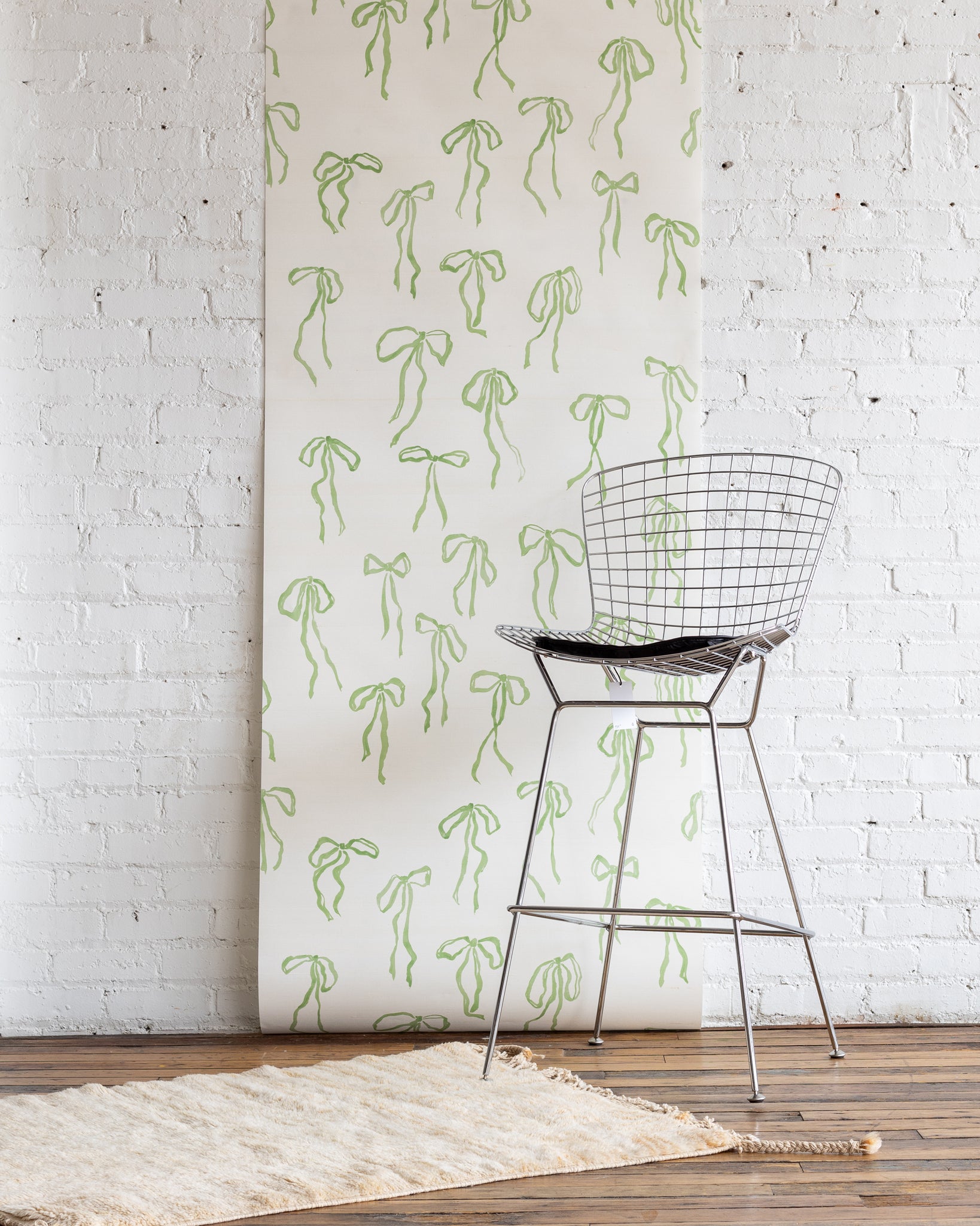 Bows wallpaper in Green Tea - natural, soft green bow design on silk wallpaper base