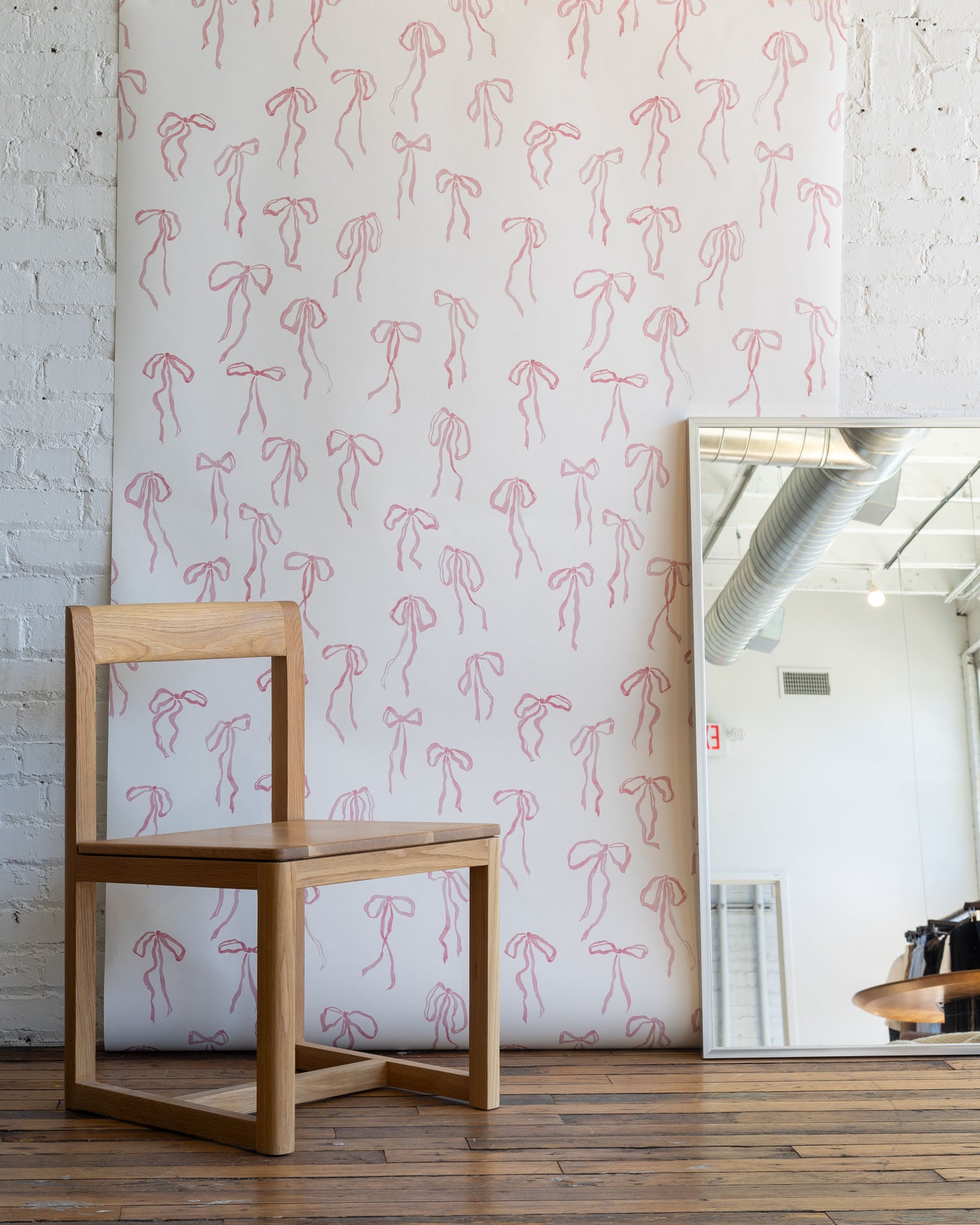 Hand-painted bow pattern in Pink Quartz, matte pink wallpaper - designed for soft, inviting spaces residential walls