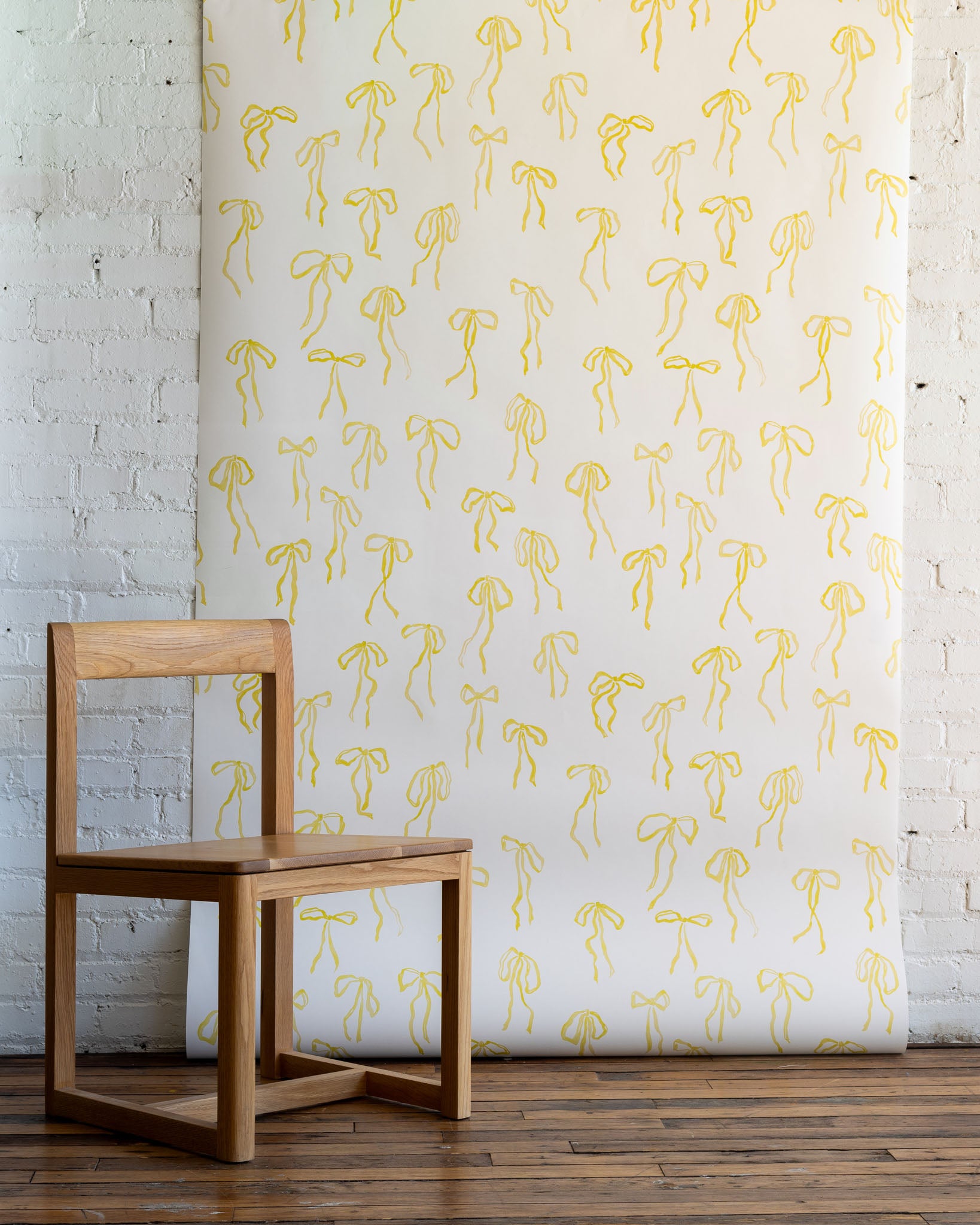 Hand-painted bow design in yellow, matte paper wallpaper for walls - vibrant, uplifting wallpaper for walls