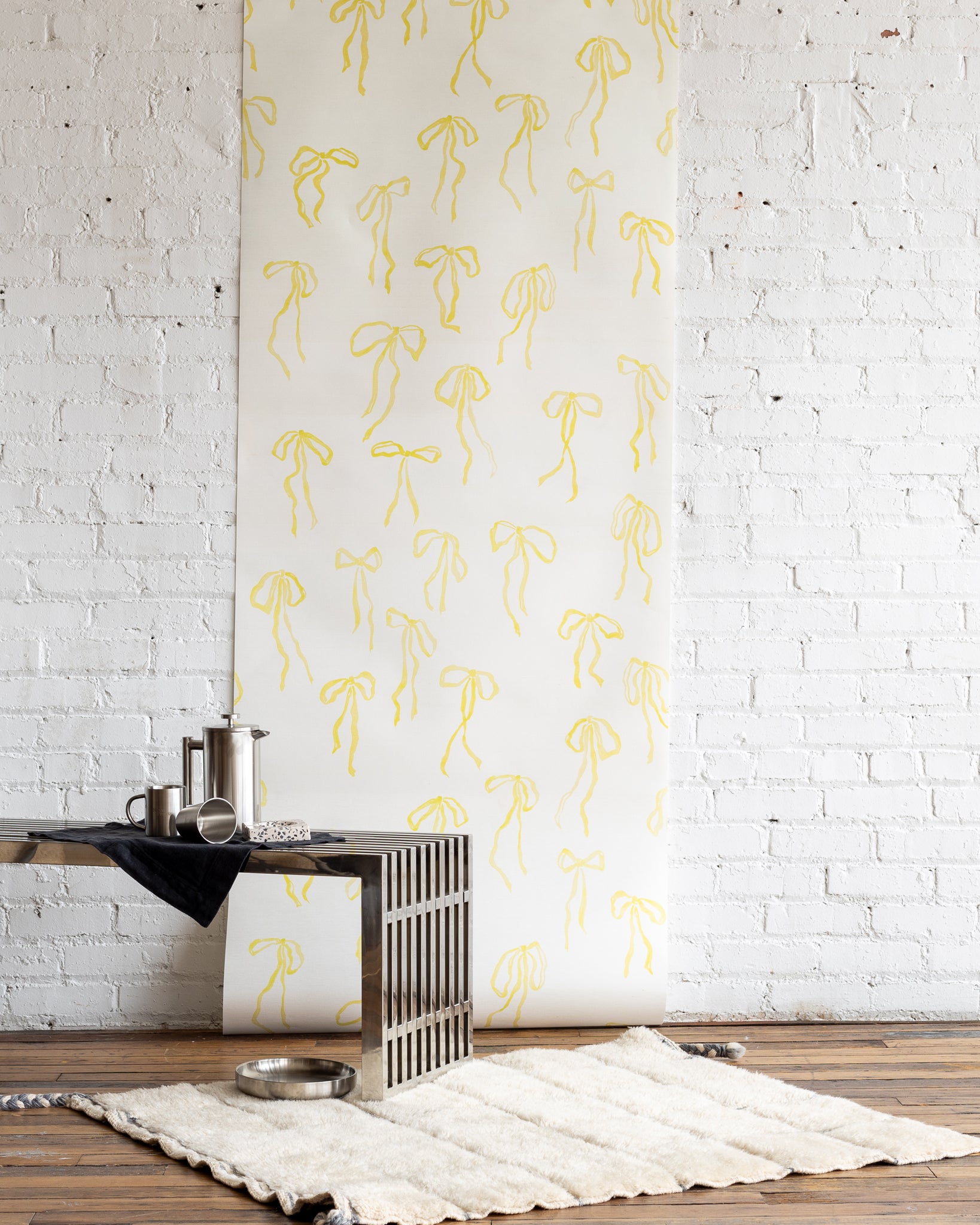 Bows wallpaper in Sun - cheerful yellow hand-painted bows on a silk wallpaper base