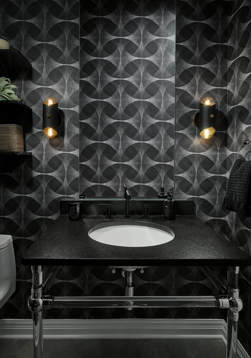 Geometric dark wallpaper adding depth and sophistication to a powder bath